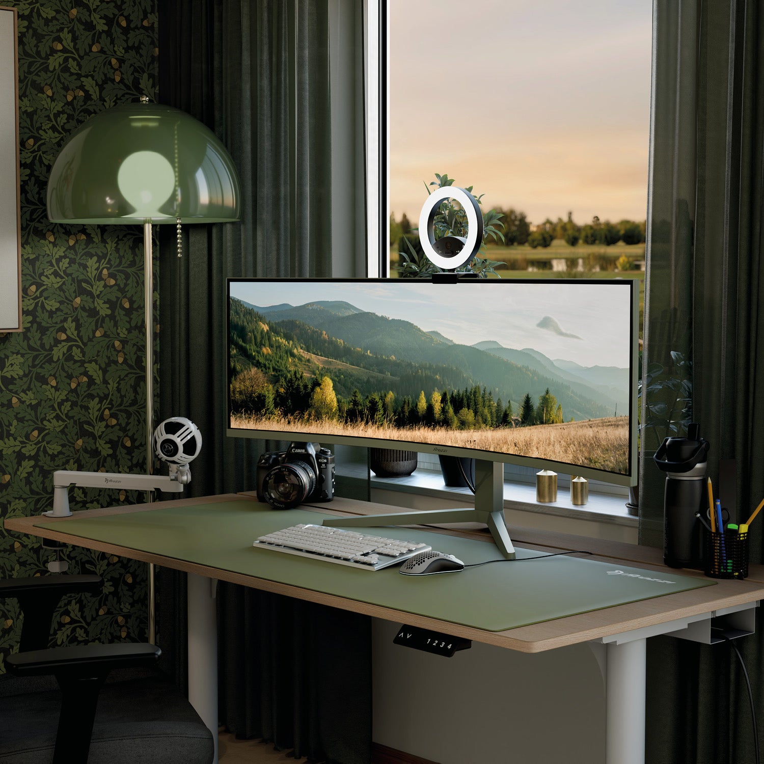Experience a sleek desk setup featuring the Arozzi Nova 49″ Curved VA 165Hz Ultrawide Gaming Monitor, showcasing a breathtaking mountain landscape. The space includes a keyboard, mouse, webcam with ring light, camera, headphones, and various accessories beside a window adorned with green curtains and leafy wallpaper. Enjoy ultra-smooth visuals thanks to the monitor’s advanced 165Hz refresh rate and adaptive sync technology.